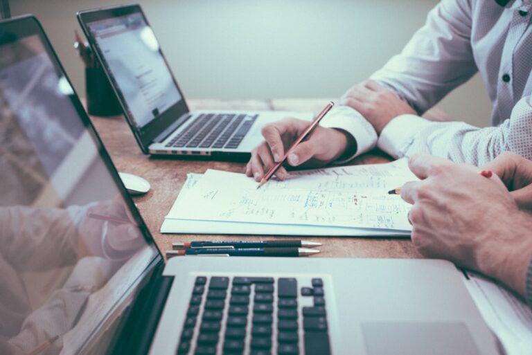 Three copier lease proposals on a desk for comparison